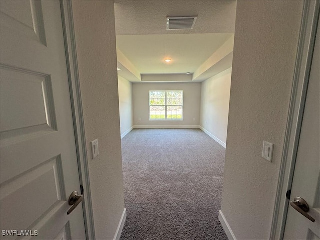 2324 Jacaranda Pkwy W, Cape Coral, FL 33993 - unfurnished room featuring visible vents, carpet floors, baseboards, a raised ceiling, and a textured wall