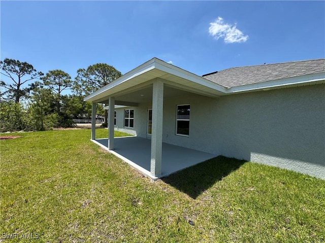 2324 Jacaranda Pkwy W, Cape Coral, FL 33993 - rear view of property with a patio, stucco siding, and a yard