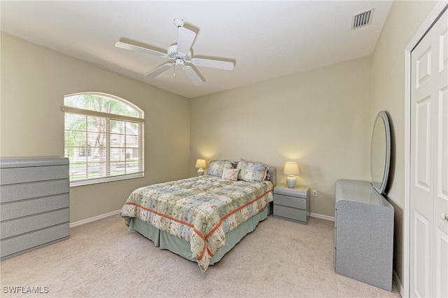 carpeted bedroom with a closet and ceiling fan