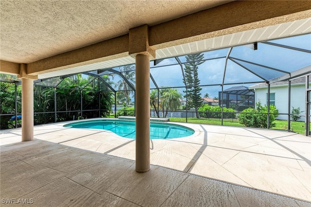 view of pool with a patio area and a lanai