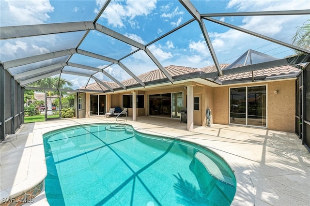 view of swimming pool with a patio and glass enclosure