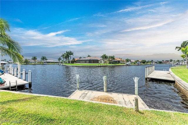 dock area featuring a water view and a yard