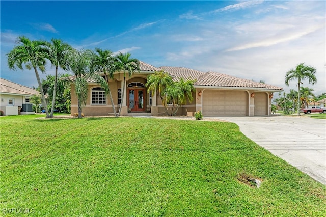 mediterranean / spanish-style house featuring a front lawn and a garage