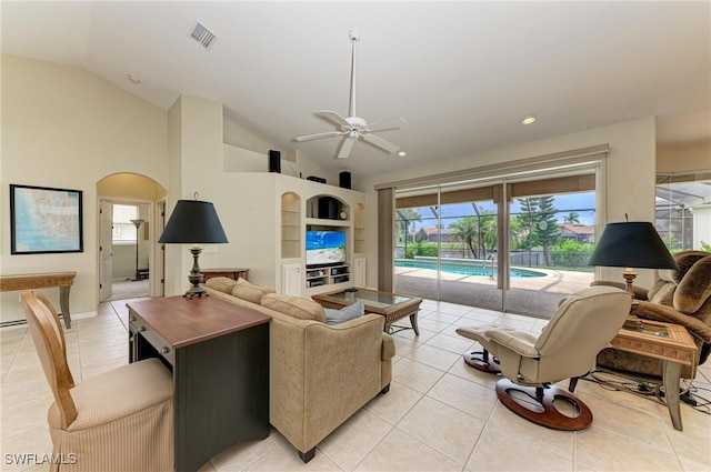 tiled living room featuring ceiling fan and vaulted ceiling