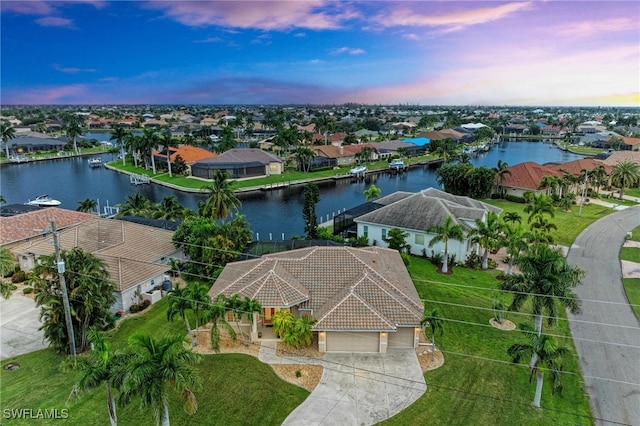 aerial view at dusk with a water view