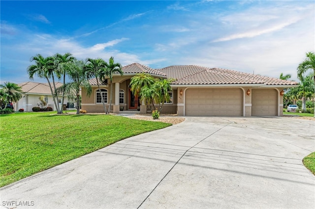 mediterranean / spanish home featuring a front lawn and a garage