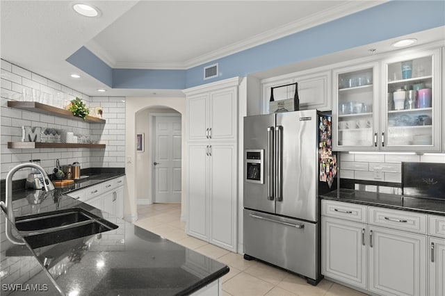 kitchen featuring sink, white cabinets, decorative backsplash, and high end fridge