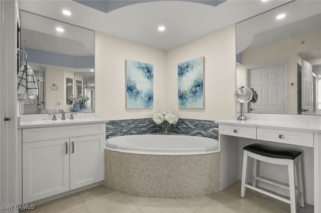 bathroom featuring vanity, tiled bath, and tile patterned flooring