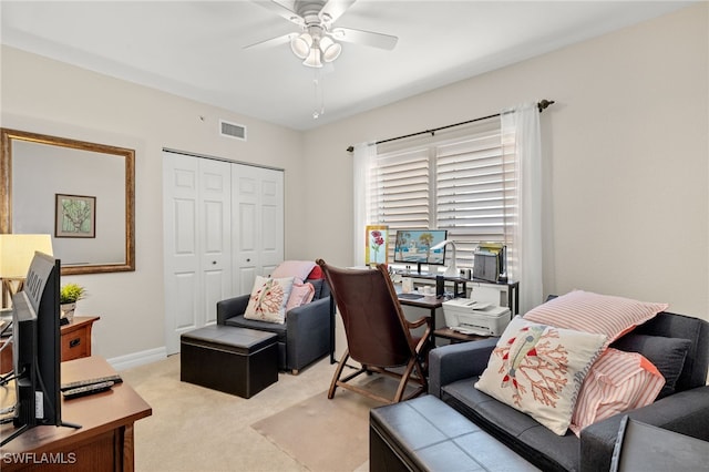 carpeted office space with ceiling fan