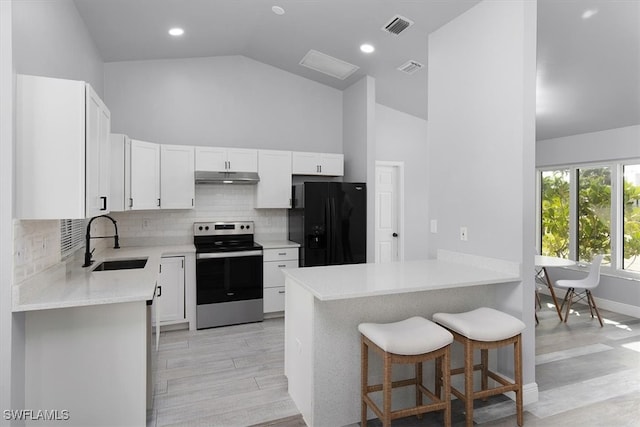 kitchen featuring sink, electric range, black fridge, white cabinetry, and light hardwood / wood-style flooring