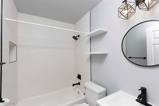 full bathroom with vanity, tiled shower / bath combo, and toilet