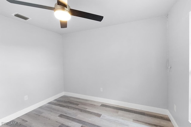 spare room with light wood-type flooring and ceiling fan