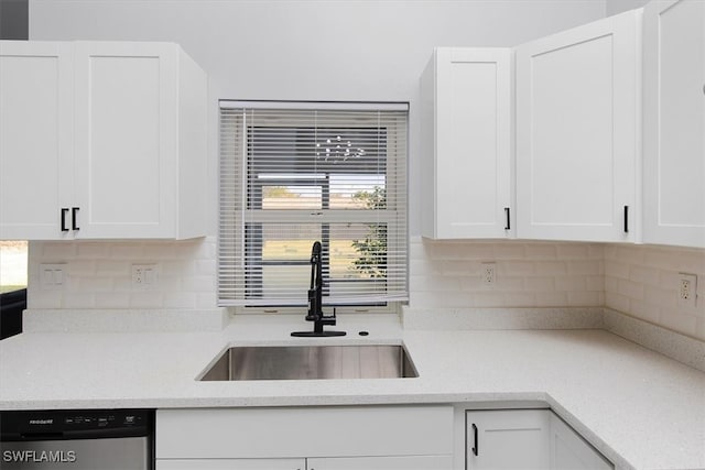 kitchen featuring white cabinetry and sink