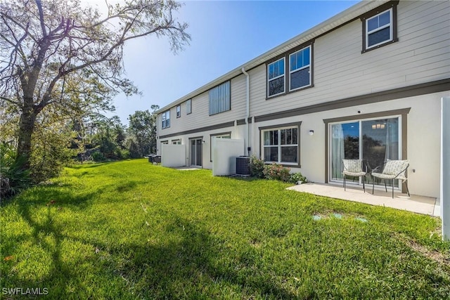 15050 Caspian Tern Ct Unit 102, North Fort Myers, FL 33917 - rear view of property featuring a yard, stucco siding, a patio, and central AC