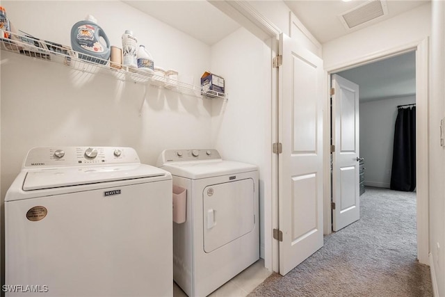 15050 Caspian Tern Ct Unit 102, North Fort Myers, FL 33917 - clothes washing area with light colored carpet, laundry area, visible vents, and washing machine and clothes dryer