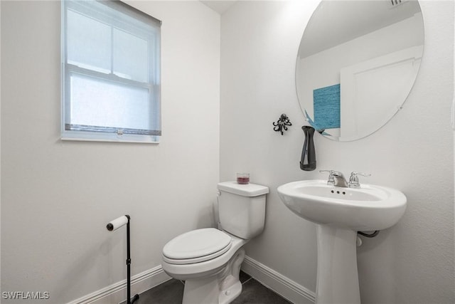 15050 Caspian Tern Ct Unit 102, North Fort Myers, FL 33917 - bathroom featuring a sink, toilet, and baseboards