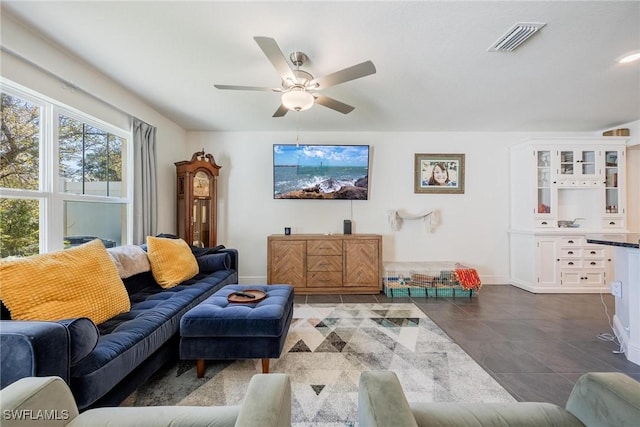 15050 Caspian Tern Ct Unit 102, North Fort Myers, FL 33917 - living area with dark tile patterned floors, visible vents, baseboards, and a ceiling fan