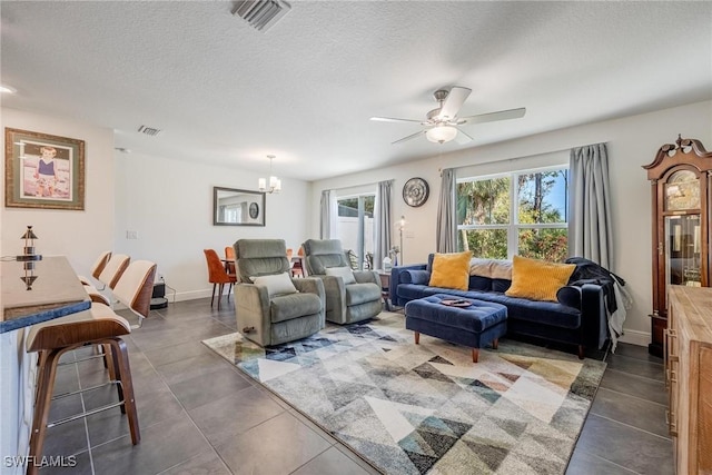 15050 Caspian Tern Ct Unit 102, North Fort Myers, FL 33917 - living area with tile patterned flooring, visible vents, and ceiling fan with notable chandelier