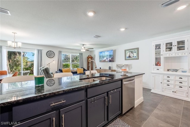 15050 Caspian Tern Ct Unit 102, North Fort Myers, FL 33917 - kitchen with dark stone counters, dishwasher, visible vents, and a sink