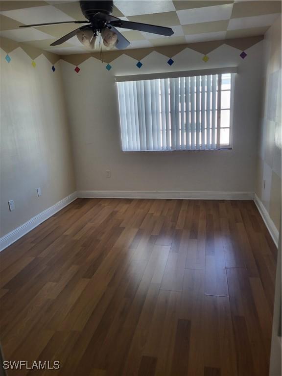 unfurnished room featuring ceiling fan and dark hardwood / wood-style floors