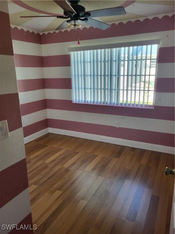 spare room featuring hardwood / wood-style flooring and ceiling fan