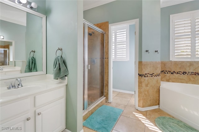 bathroom featuring tile patterned flooring, shower with separate bathtub, and vanity