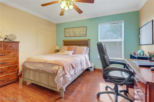 bedroom featuring ceiling fan, wood-type flooring, and crown molding