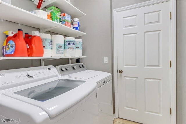 laundry area featuring light tile patterned floors and separate washer and dryer