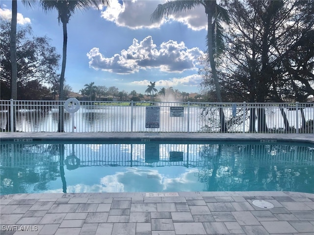 view of swimming pool with a water view