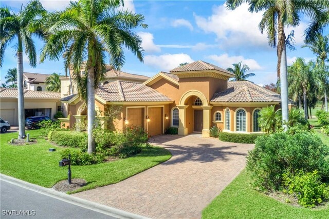 mediterranean / spanish-style house featuring a front lawn