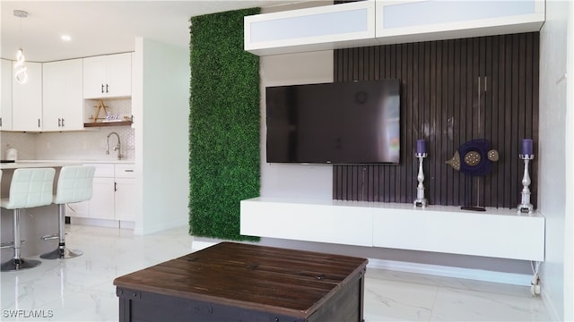 unfurnished living room featuring sink