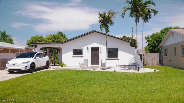 view of front of property with a carport and a front yard