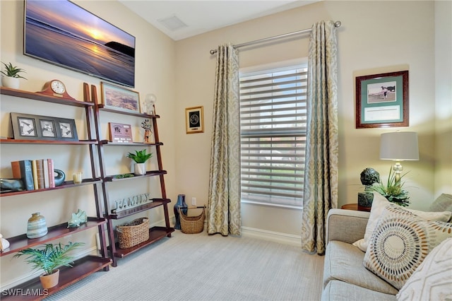 living area featuring light carpet