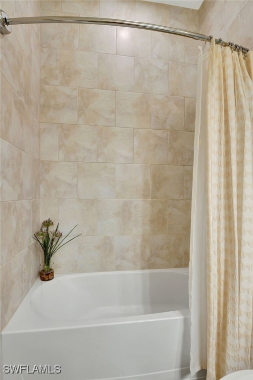 bathroom featuring shower / bathtub combination with curtain