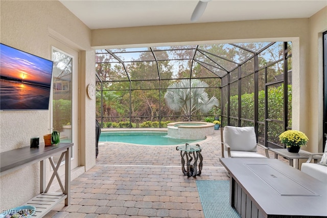 view of swimming pool featuring a patio, a lanai, and an in ground hot tub