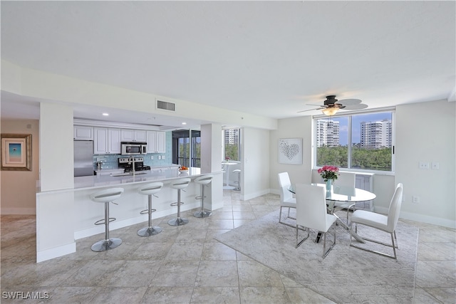 dining space featuring a wealth of natural light and ceiling fan