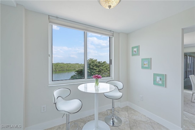 tiled dining area with a water view