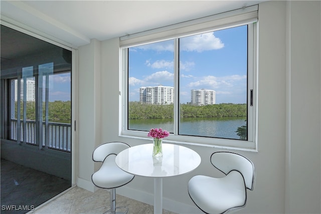 tiled dining space with a water view