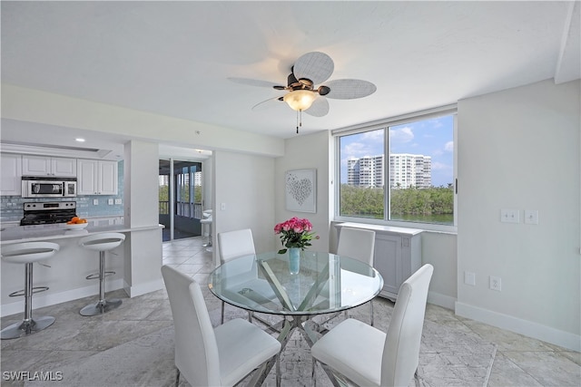 tiled dining room with ceiling fan