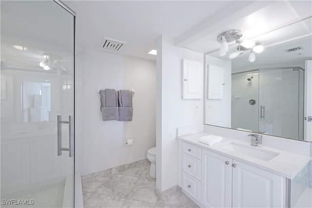 bathroom with an enclosed shower, vanity, and toilet