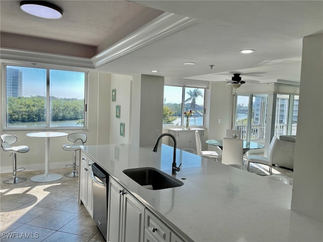 kitchen featuring white cabinetry, sink, ceiling fan, light tile patterned floors, and dishwasher