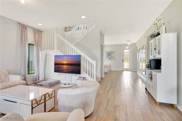 living room featuring light hardwood / wood-style floors and a healthy amount of sunlight