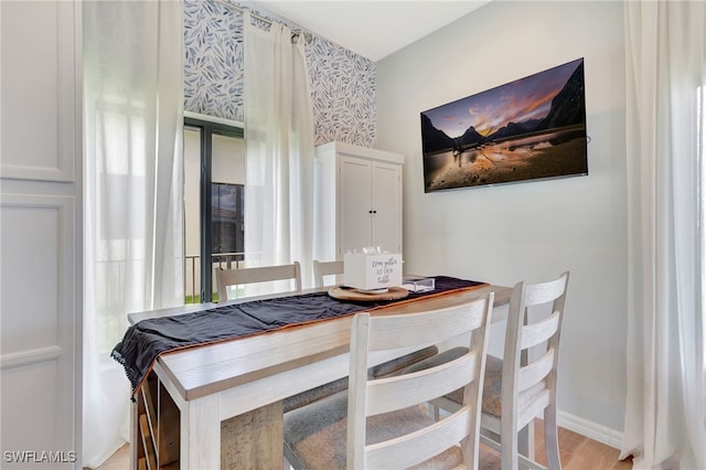 dining space with light hardwood / wood-style flooring