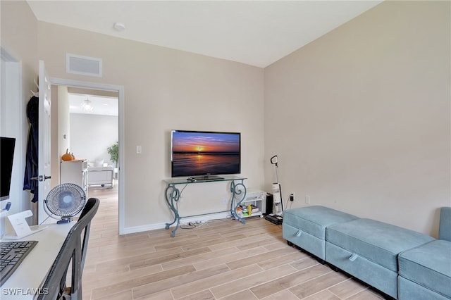 living room with light hardwood / wood-style flooring