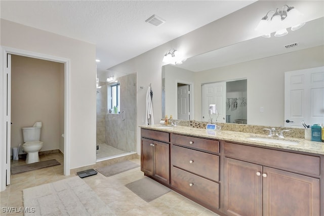 bathroom featuring tile patterned floors, toilet, vanity, a textured ceiling, and an enclosed shower