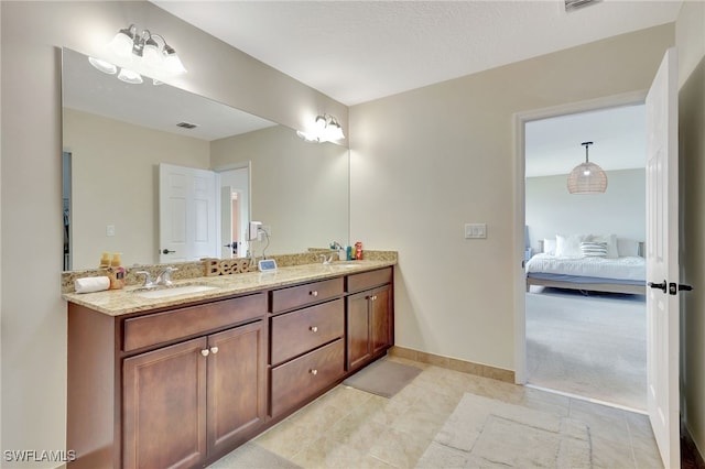 bathroom featuring vanity, a textured ceiling, and tile patterned floors