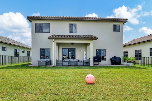 rear view of house with a patio, a lawn, and an outdoor hangout area