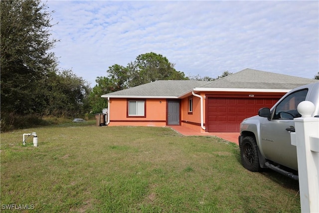 ranch-style house featuring a front yard and a garage