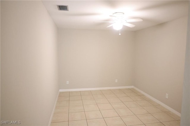 spare room featuring ceiling fan and light tile patterned flooring