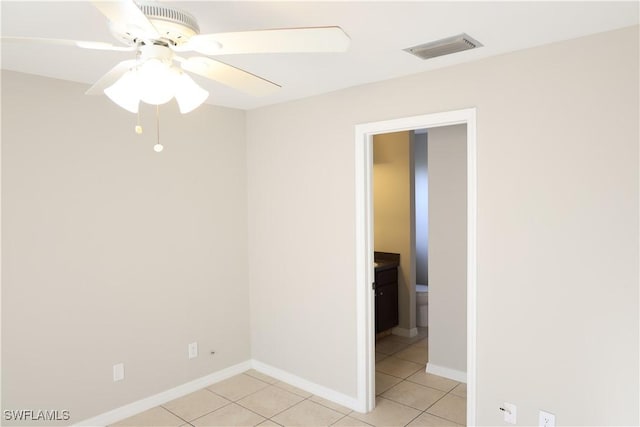 tiled empty room with ceiling fan